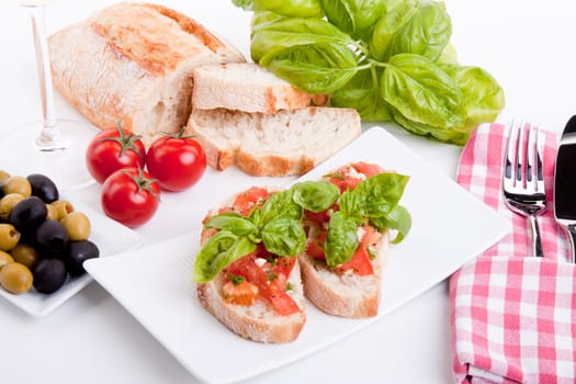 deliscious fresh bruschetta appetizer with tomatoes isolated on white background