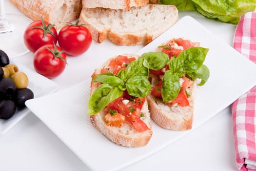 deliscious fresh bruschetta appetizer with tomatoes isolated on white background