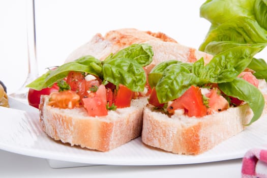 deliscious fresh bruschetta appetizer with tomatoes isolated on white background