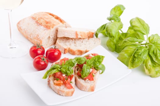 deliscious fresh bruschetta appetizer with tomatoes isolated on white background