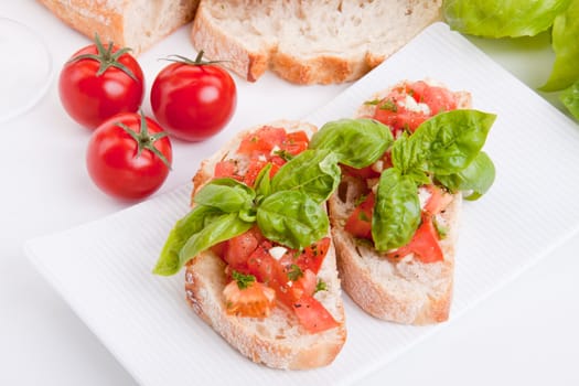 deliscious fresh bruschetta appetizer with tomatoes isolated on white background