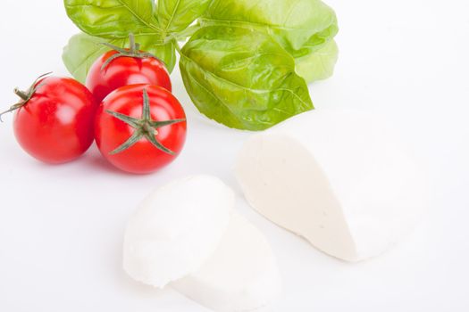 tasty tomatoe mozarella salad with basil isolated on white background