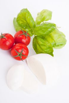 tasty tomatoe mozarella salad with basil isolated on white background