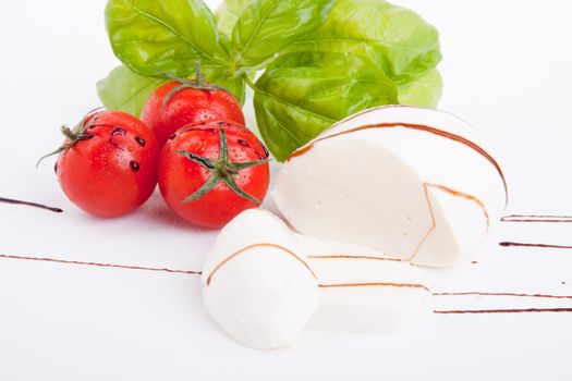 tasty tomatoe mozarella salad with basil isolated on white background