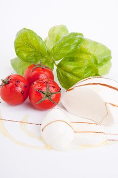 tasty tomatoe mozarella salad with basil isolated on white background