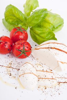 tasty tomatoe mozarella salad with basil isolated on white background