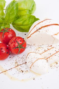 tasty tomatoe mozarella salad with basil isolated on white background