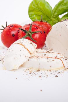 tasty tomatoe mozarella salad with basil isolated on white background