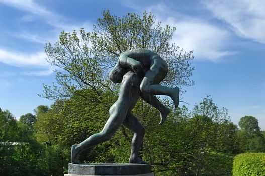 sculpture of a man bears another man in the Vigeland park, Oslo