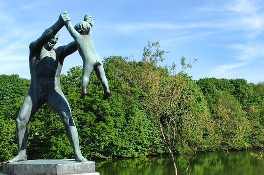 sculpture of a man playing with a child in the Vigeland park, Oslo