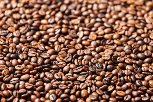 Brown roasted raw coffee bean heap background