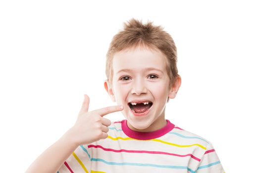 Little smiling child boy hand pointing his first baby milk or temporary teeth fall out
