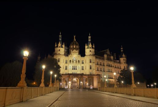 Front view of the Schwerin Castle by night. The Schwerin Castle is the seat of the state parliament of Mecklenburg-Vorpommern.