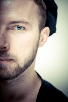 vintage half portrait of fashion guy with hat on gray background