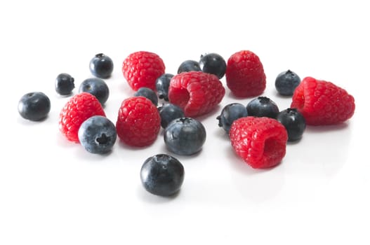 Bluesberries and Raspberries isolated on the white background