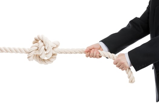 Competition concept - business man in black suit hand holding or pulling rope with tied knot white isolated