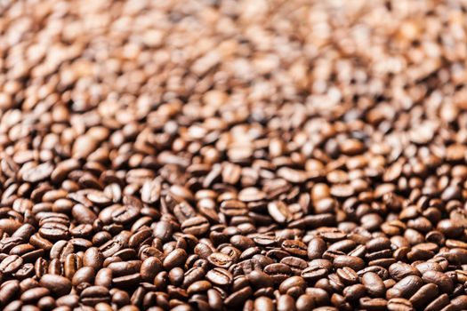 Brown roasted raw coffee bean heap background