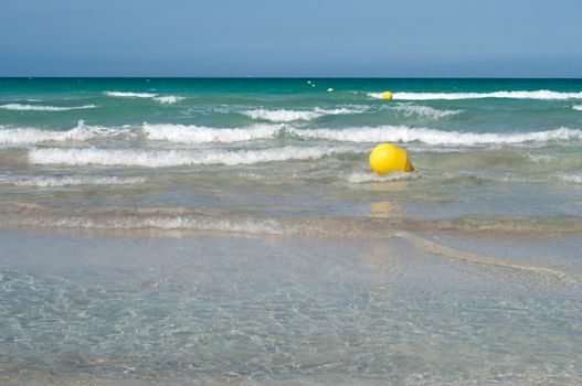 Yellow buoy in the beautiful blue sea