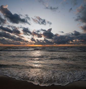 Vertical panaroma created with two horizontals placed on top of each other - one mostly sky and the other ocean