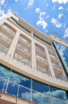 Modern building with reflection of sky on it