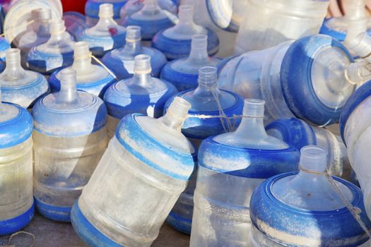 Dwarka Roadtrip. Empty drinking water bottles for dispensers gathering dust on the Quayside. Shot location, Dwarka, Gujarat, India