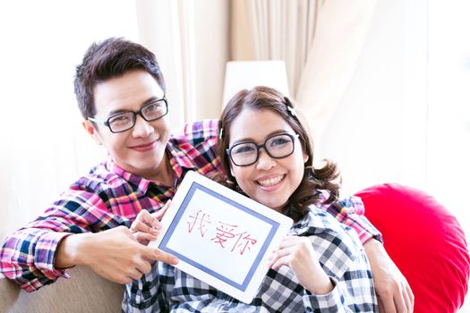 Couples with a tablet computer in living room