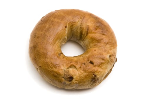 A single cinnamon bagel on white background