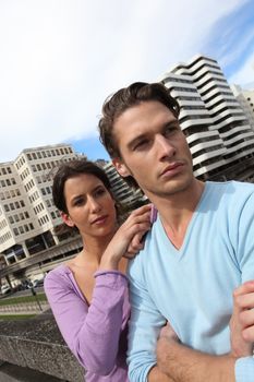 Couple in front of tall buildings area