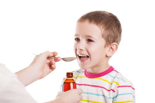 Doctor hand giving spoon dose of medicine liquid drinking syrup to child boy patient