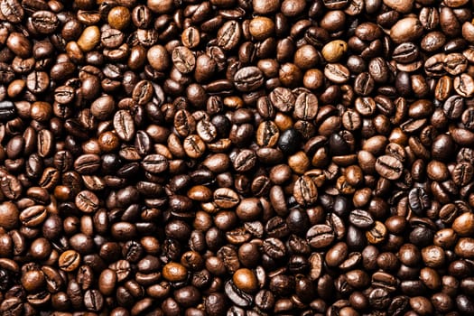 Brown roasted raw coffee bean heap background