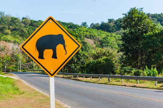 Road sign "caution elephants" on the track in Thailand