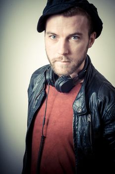 vintage portrait of fashion guy with headphones on gray background