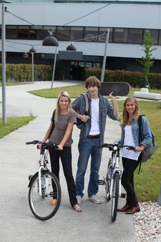 Young people with bicycles and skateboard