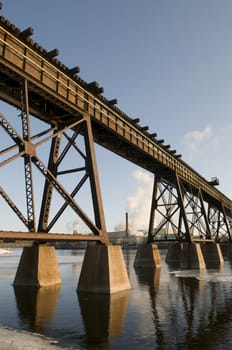 Factory in the background with train bridge in the foreground