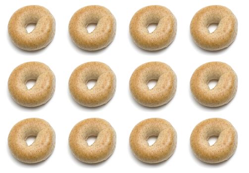 One dozen whole wheat bagel isolated on white.