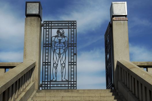 entrance an iron gate to Vigeland park , depict a naked man, Oslo, Norway