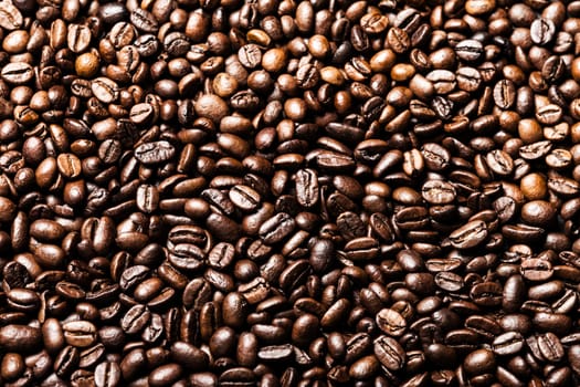 Brown roasted raw coffee bean heap background