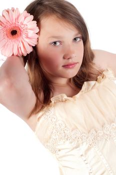 Teenager girl with gerbera isolated on white