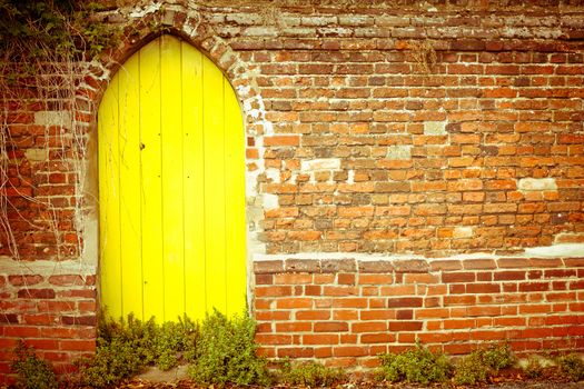 Nice yellow gate in a red brick wall