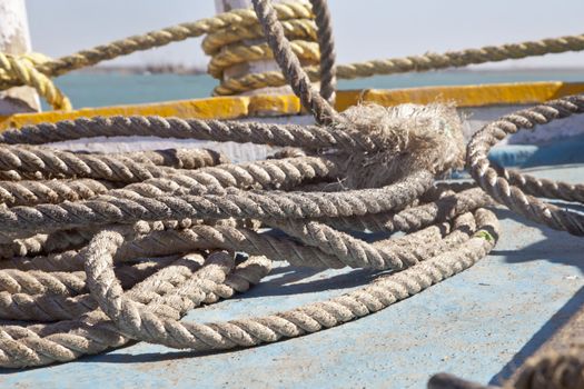 Horizontal abstract image of coiled mooring rope shapes on a ferry at Bet Dwarka, Gujarat, India