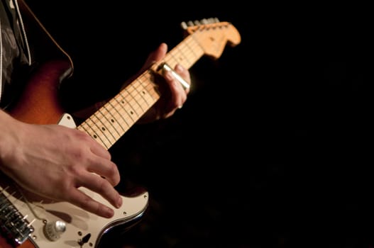 Close up on the hands of a guitar player with copy space in the background