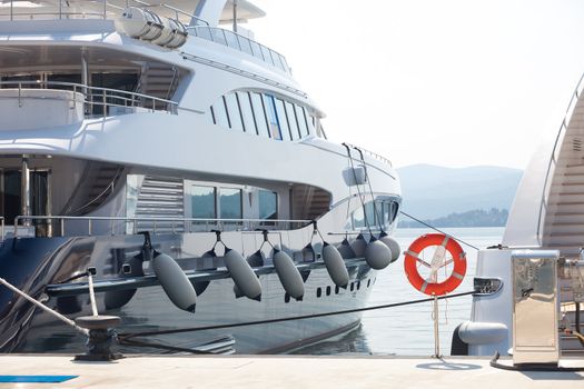 expensive white luxury yacht moored at port in Montenegro