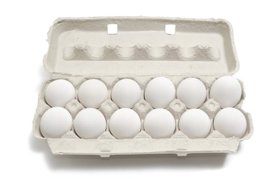 A dozen eggs in a carton isolated on white background