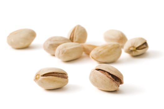 Selective focus on two pistachios on white background