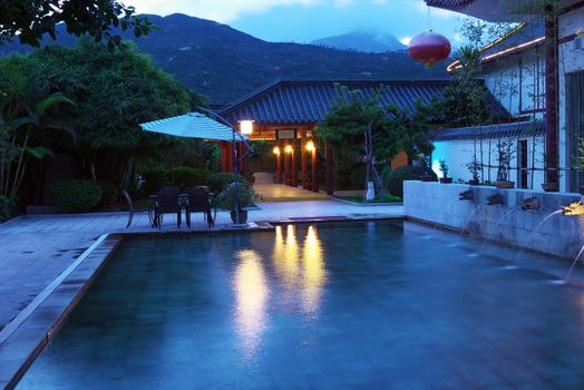 Chinese style hot spring pool with dragon head statues flowing out water