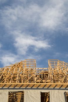 Wood framing construction on a large building with copy space in the blue sky area