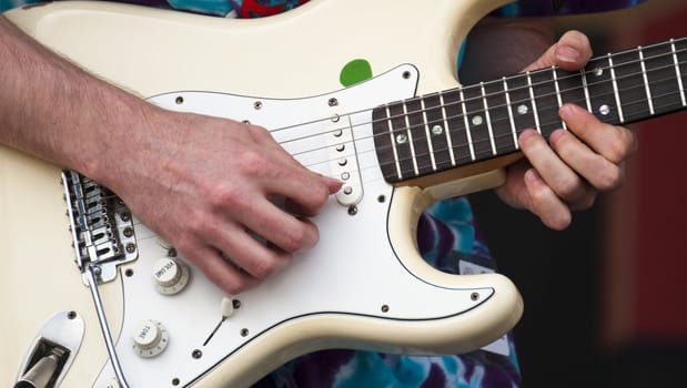 Closeup of a electric guitar and musician picks out some slick riffs