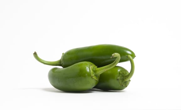 Three hot jalapeno peppers on white background.