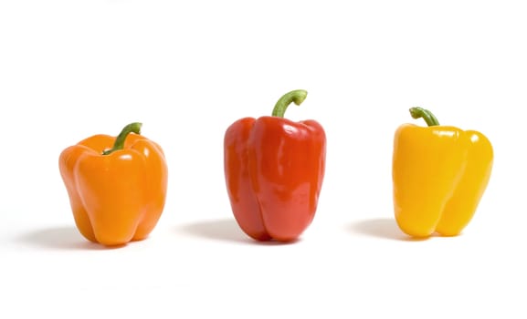 Orange, red and yellow peppers isolated on a white background.