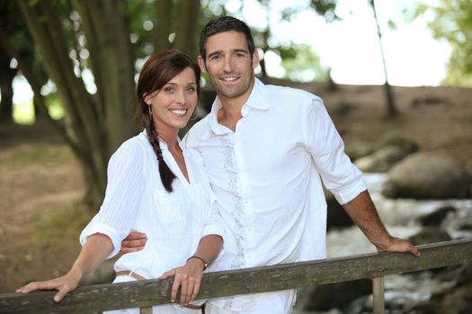 Attractive couple taking a summer stroll through the woods